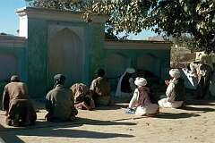 Afternoon prayers near a shrine in the village of Del Khatay on the outskirts of Kandahar.