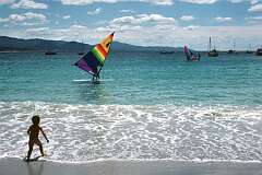 Windsurfing along the beach of Bicheno.