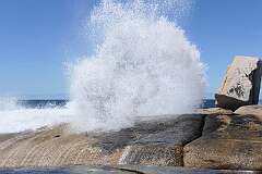 The Bicheno Blowhole, a hole in the granite rocks emitting small waves into powerful jets of water, on Tasmania's east coast.