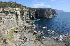 View of the steep cliffs of Tasman Peninsula from the Waterfall Bay Track, in Tasman National Park.