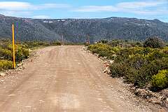 Looking at snow patches on the mountains, from the Lake Dobson Road in Mount Field National Park, with markers when there is high snowfall.