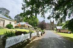 View to the Church of Port Arthur penal station and Civil Officer's Row, separating senior officers and their families from the convict population and provided them with housing suited to their status. Across the road is the Anglican St David’s Church (1927), one of several buildings and areas remaining from the post-convict period as the township of Carnarvon.