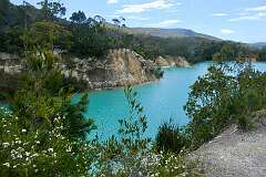 Little Blue Lake, 8 kilometres southwest of Scottsdale in northeast Tasmania. Originally a mine hole, the lake reflects a vivid aqua blue from the minerals in its base.