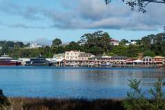 The harbour of Strahan, 41 kilometres west of Queenstown. In 1896 it was connected to Queenstown by a railway.