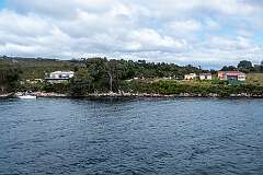 View of the small rural settlement at Macquarie Heads, on the western side of the entrance to Macquarie Harbour; it has no road access.