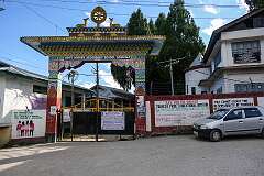 The gate of the Higher Secondary School, with its Buddhist symbols: the deer and wheel specifically represent the Buddha’s first teaching after his awakening when he “turned the wheel of the Dharma” at Deer Park near Sarnath, India.