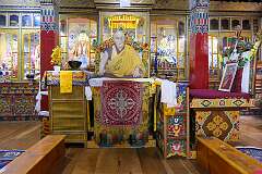In the Dukhang, the main assembly hall of the Lower Gompa, a division of the Gontse Gaden Rabgyel Ling Monastery, with on the throne a life-size cutout picture of the 14th Dalai Lama.