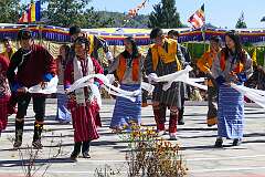 Students perform a Tibetan group dance, with “khata” ceremonial shawls. The two dancers at left have Monpa dress and headgear.