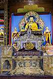A life-size cutout image of the 14th Dalai Lama on the throne under a statue of the Buddha in the main prayer hall of the Thupsung Dhargye Ling Monastery.