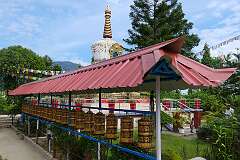 Prayer wheels with the mantra “Om Mani Padme Hum” in Tibetan script; at the Gompa Buddhist Temple.