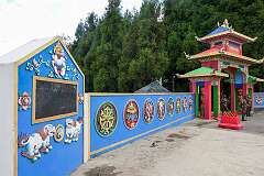 The gate and wall, with Buddhist symbols, to a military base opposite the Tawang War Memorial.