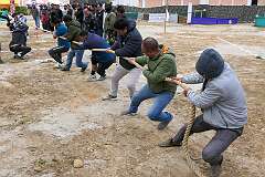 Men playing “Thekpa-teng-ri”, tug-of-war, in the Tawang Festival showground.