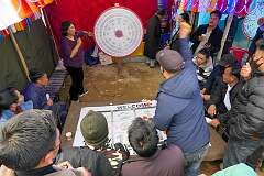 Throwing a dart at a rotating board, a roulette game, one of the activities at the festival showgrounds.