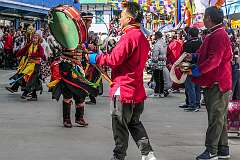 Women dancers with headdresses, accompanied by drum and cymbal, in the Carnival Parade on the first day of the Tawang Festival.