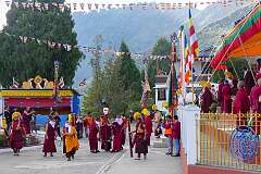 Monks with ceremonial headdresses and the “Torma”, spiritual cake.