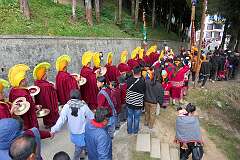 Monks with ceremonial headdresses leading the procession for the burning of the “Torma”, spiritual cake, carrying pairs of Cymbals (“Bub”) and followed by a big crowd at the Drub-chod-Chen-Mo Cum Bomdila Torgya.