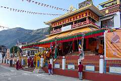 Monks with ceremonial headdresses returning into the main hall of the Gontse Gaden Rabgyel Ling Monastery, at the end of the second day of the Torgya ceremonies.