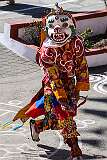 A masked dancer during the temple ceremony.