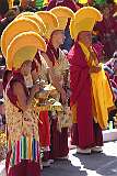 Monks with ceremonial headdresses and Gya-Ling instruments.