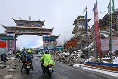 The Welcome Gate to Tawang on the Sela Pass, at 4175 metres above sea level, on the road to Tawang. Above it is a shrine with a Buddha statue.