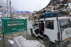 A Tata Sumo at the welcome sign on the Sela Pass, 4175 metres above sea level, on the road to Tawang.