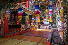The fierce-looking Buddhist sage Padmasambhava, flanked by his Indian and Tibetan wives, in the main prayer hall of the Khinmey Nyingma Monastery.