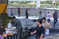 Devotees circumambulating the Shiv Linga, while a man pours sacred water over a small lingam, at the Shree Sidheshwar Nath Temple.