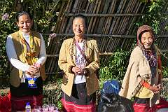 Women with drinks along the road, for the people at the Eli ceremony in Tajang Village.
