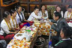 A man gives money to one of the wedding guests in the house of the Radhe clan, during the Eli ceremony, Tajang.