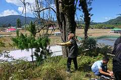 Millo Nyime, a Danyi Piilo (Donyi Polo) Nyibus or priest, shooting a small arrow from a bow, in both directions for men and women.
