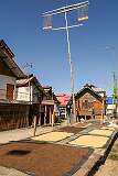 Ceremonial poles of the Donyi Polo religion and drying millet and rice in Hari Village.
