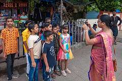Photographing a group of children near the Railway Station of Guwahati.