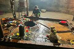 Offers of flowers in the inner sanctum of Siva Dol, the 18th-Century temple of Shiva.