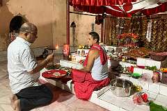 Devotee with a priest in the inner sanctum of Devi Dol, the 18th-Century temple of Vishnu, in Sivasagar.