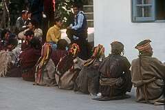 Kulu Tibetan people waiting at the gate to the palace of the Dalai Lama in McLeod Ganj, a suburb of Dharamshala and known as “Little Lhasa” because of its large population of Tibetans.