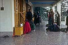 Devotees praying at an entrance portal of the Dalai Lama's temple, the Tsuglagkhang.