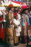 A scene in the Lhamo (Tibetan Opera) performance, a boy draped with “khatag” ceremonial shawls between his parents.