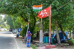 The flag with the spinning wheel (Gandhi's choice for a national flag, symbolising small scale domestic production) and the flag of the	Communist Party of India (Marxist), along the Alappuzha - Arthunkal - Kochi Road in Pallithode, Kodamthuruth.