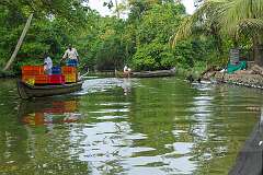 Men in canoes on the backwaters of Kodamthuruth.
