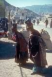 Two Ladakhi women, in traditional dress and carrying heavy loads, in Leh.