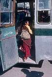 A young novice monk steps into a bus, Leh.