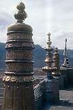 Brass ornaments with Tibetan inscriptions on the roof of the monastery.