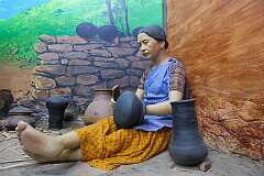 Display of a woman with pots, of tribal people, in the Don Bosco Centre for Indigenous Cultures, Shillong.