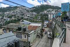 View of Aizawl near the Zotlang Presbyterian Church from the Luangmual Road, Zotlang, Aizawl. The sign in Mizo language promotes testing for HIV Aids: “Don't be afraid to test, you will get treatment soon”.