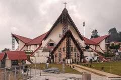 Kohima Cathedral Church on Aradura Hill during renovation. Its architecture incorporates many elements of traditional Naga houses, including its façade which resembles that of a Naga house.