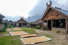 The square with traditional houses and drying rice, in the upper Angami Naga village of Khonoma.