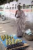 A woman selling fruit on the street in Thanjavur.