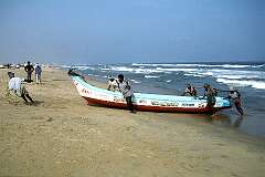 Fishermen pulling their boat ashore on Marina Beach.