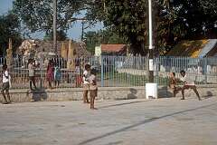Boys playing a game of cricket on the street, Kanchipuram.