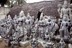Statues of Hindu deities next to one of the workshops of stone carvers.